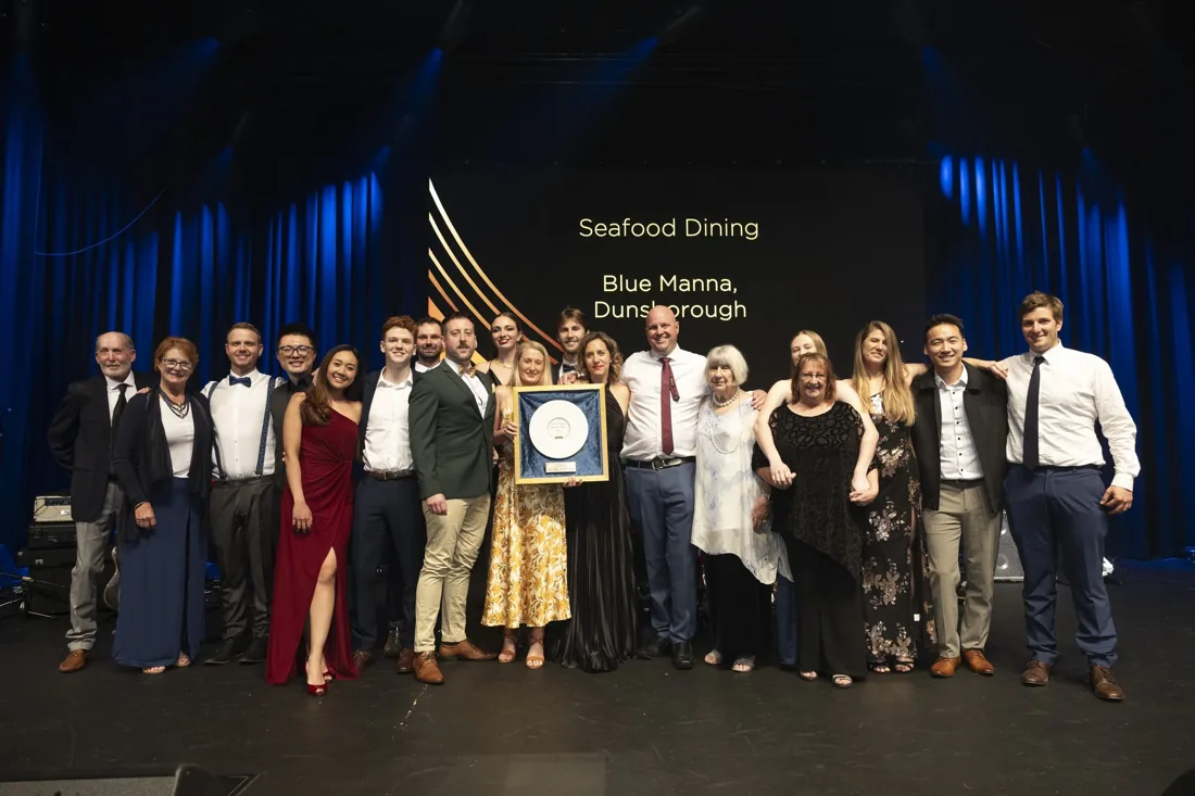 The Blue Manna Bistro team accepting a national seafood award on stage