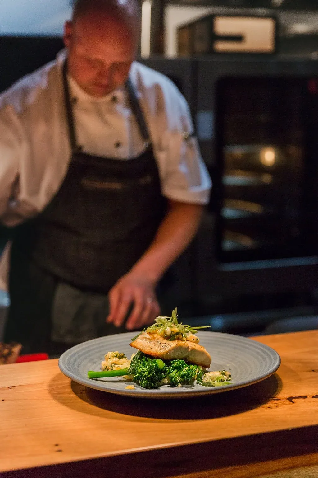 Chef and owner Coby plating a dish at Blue Manna Bistro